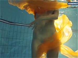 Yellow and red clothed teenager underwater